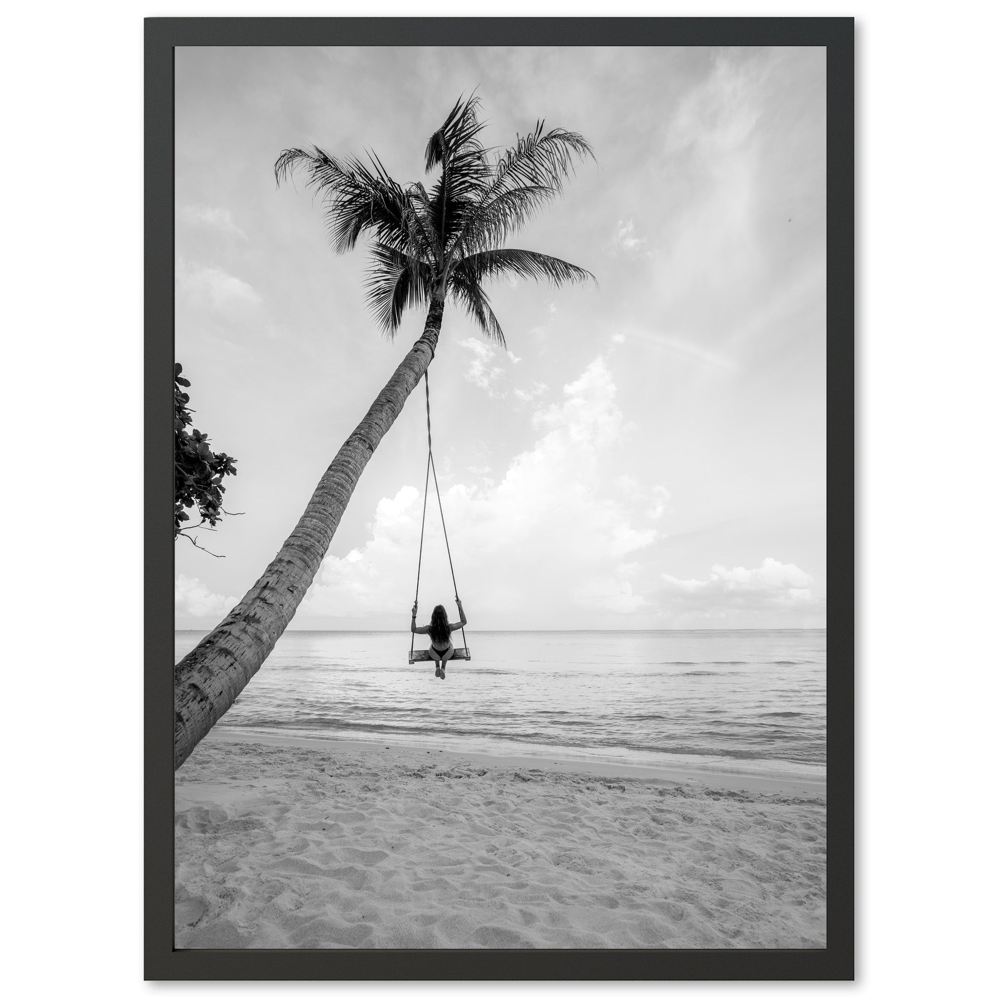 a black and white photo of a person on a swing