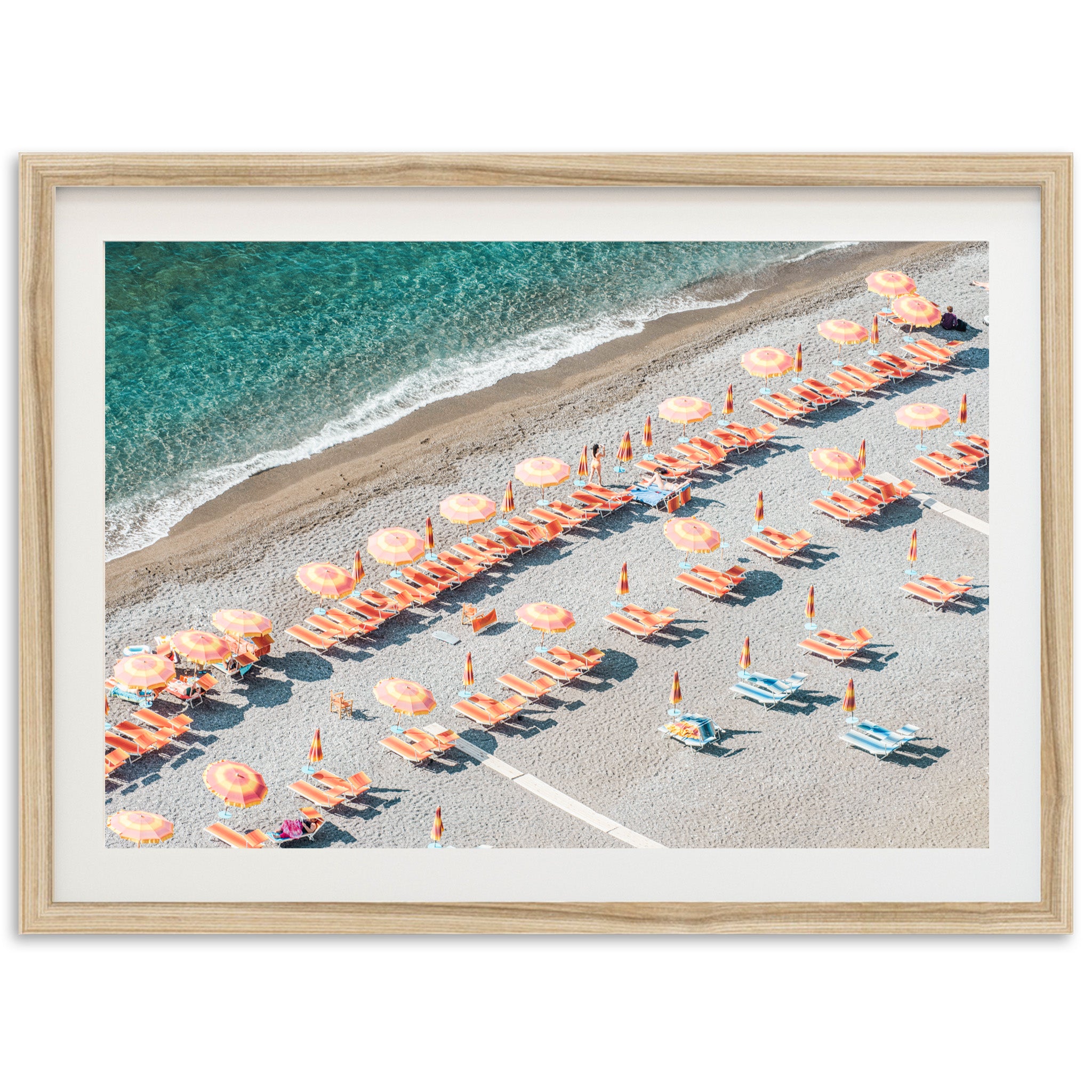 an aerial view of a beach with umbrellas and chairs