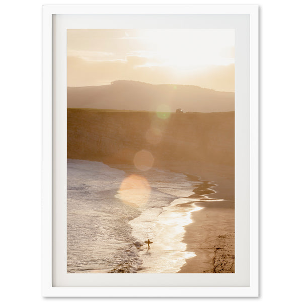 a picture of a beach with a person on a surfboard