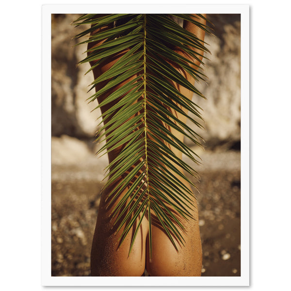 a woman's butts are covered by a palm leaf