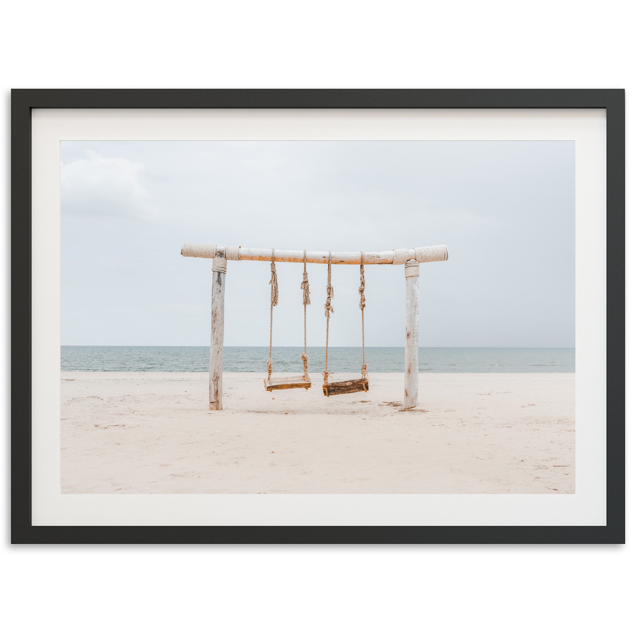 a picture of a swing on the beach