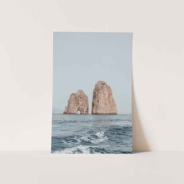 a picture of two rock formations in the ocean