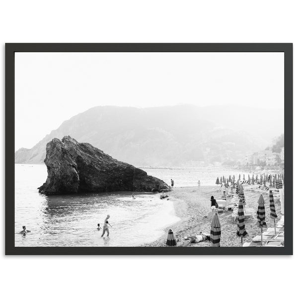 a black and white photo of people on a beach