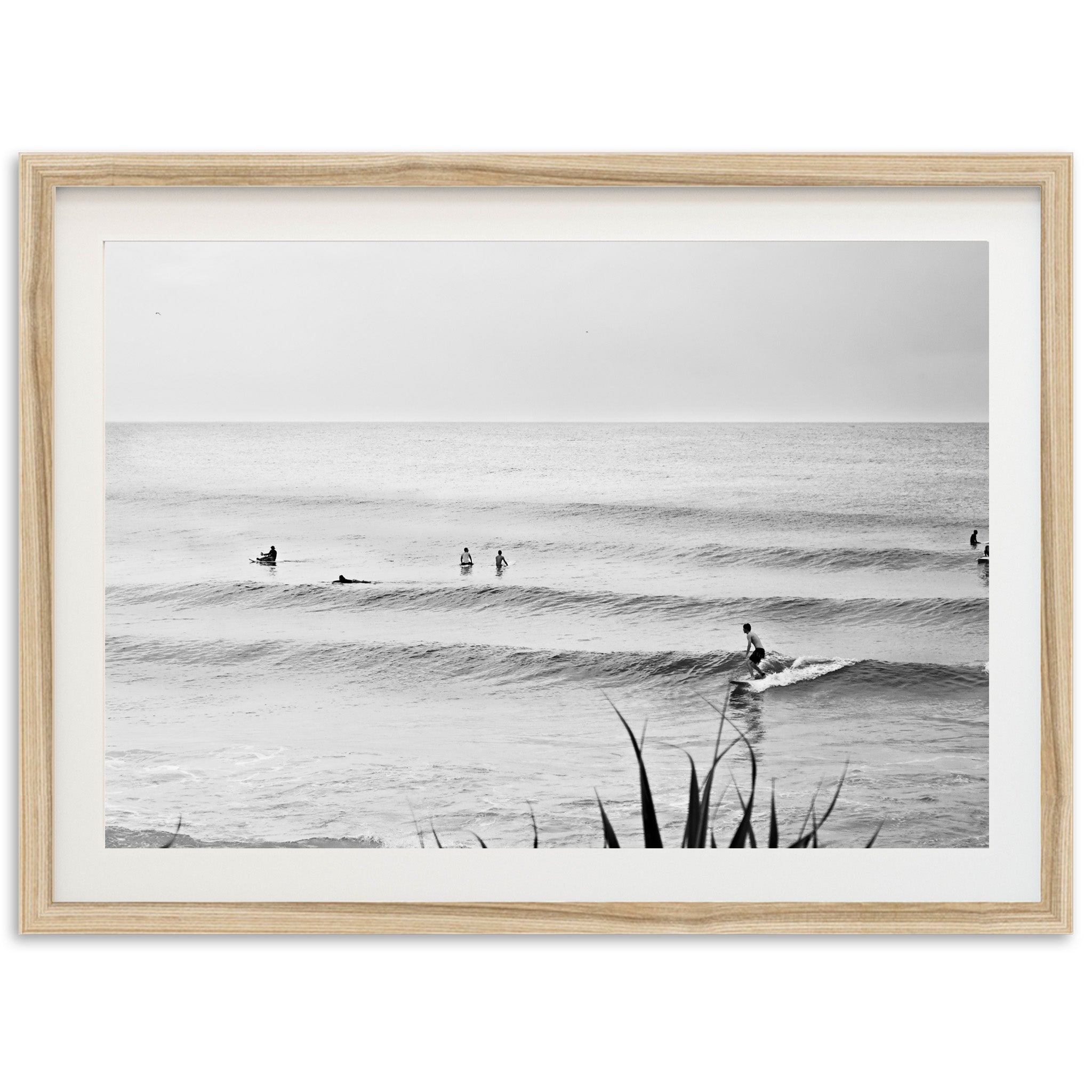 a black and white photo of surfers in the ocean