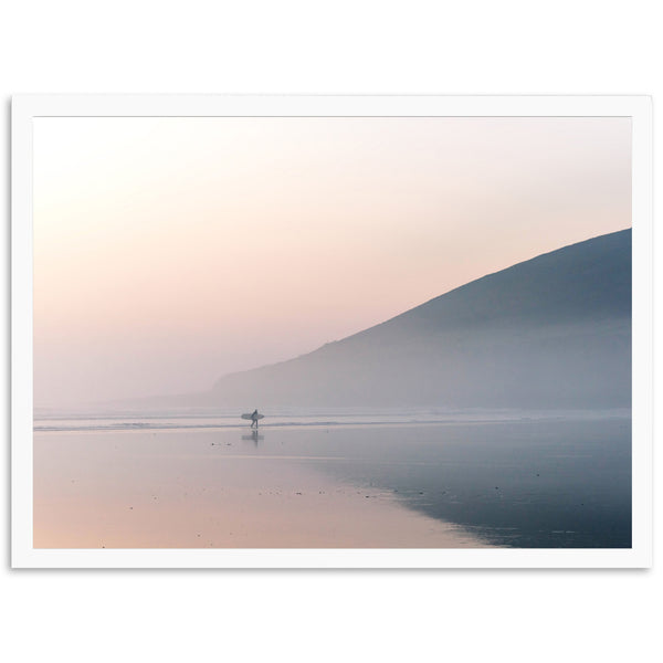 a lone person is standing in the water on a foggy day