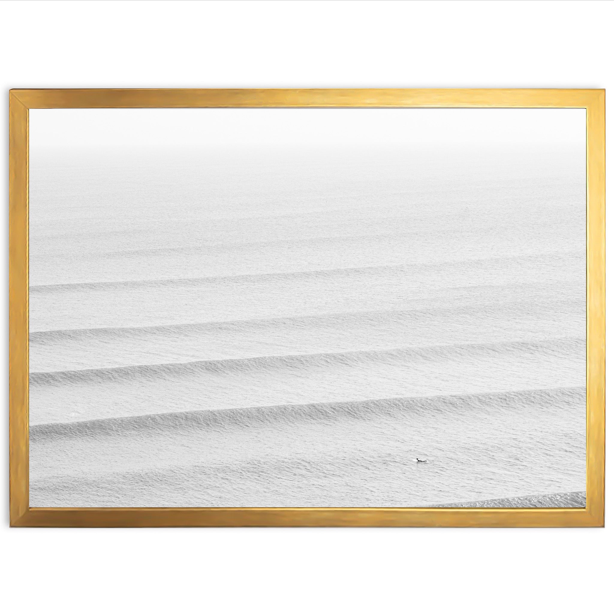 a picture of the ocean in a gold frame