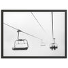 a black and white photo of a ski lift