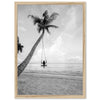 a black and white photo of a person in a hammock on a beach