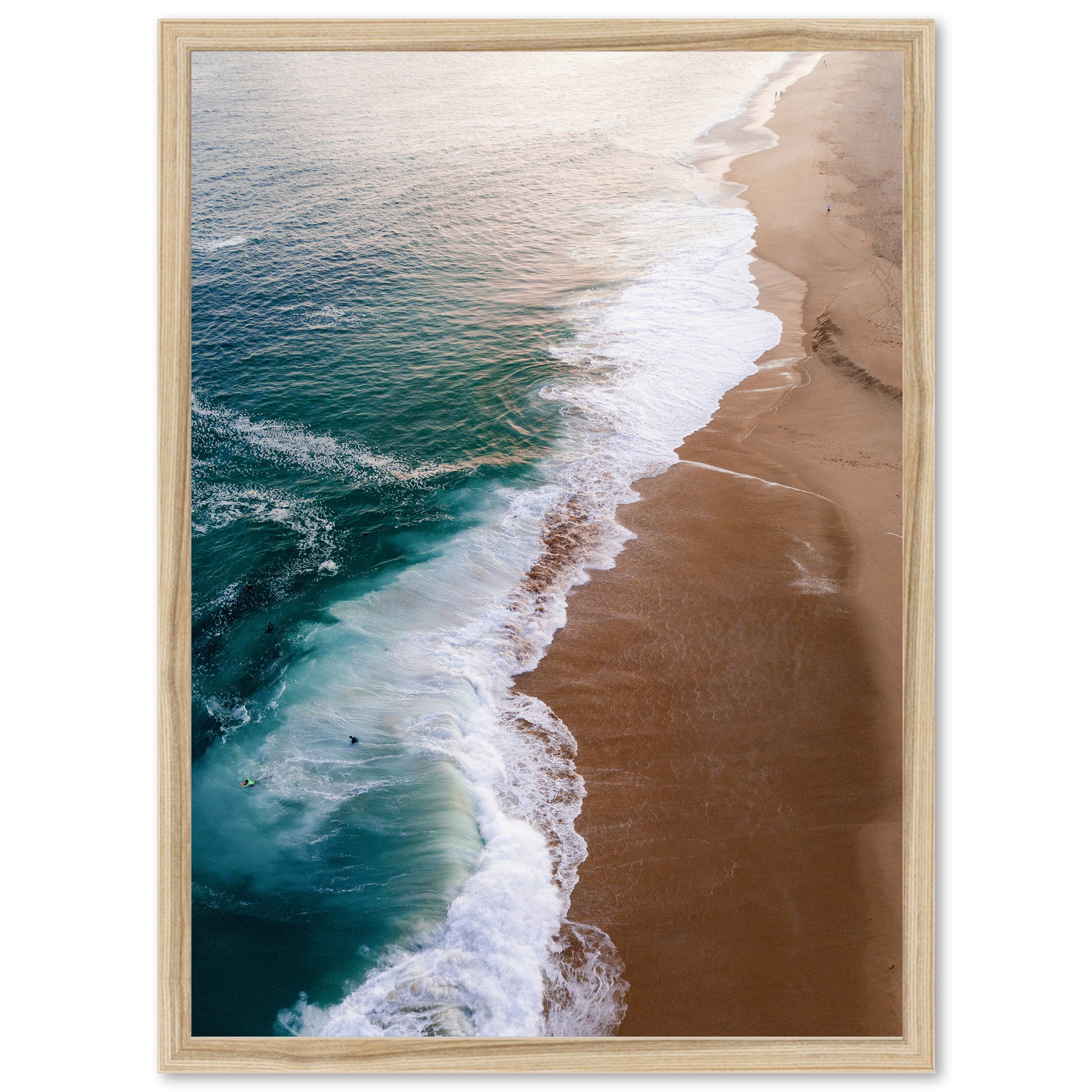 an aerial view of a beach with a wave coming in