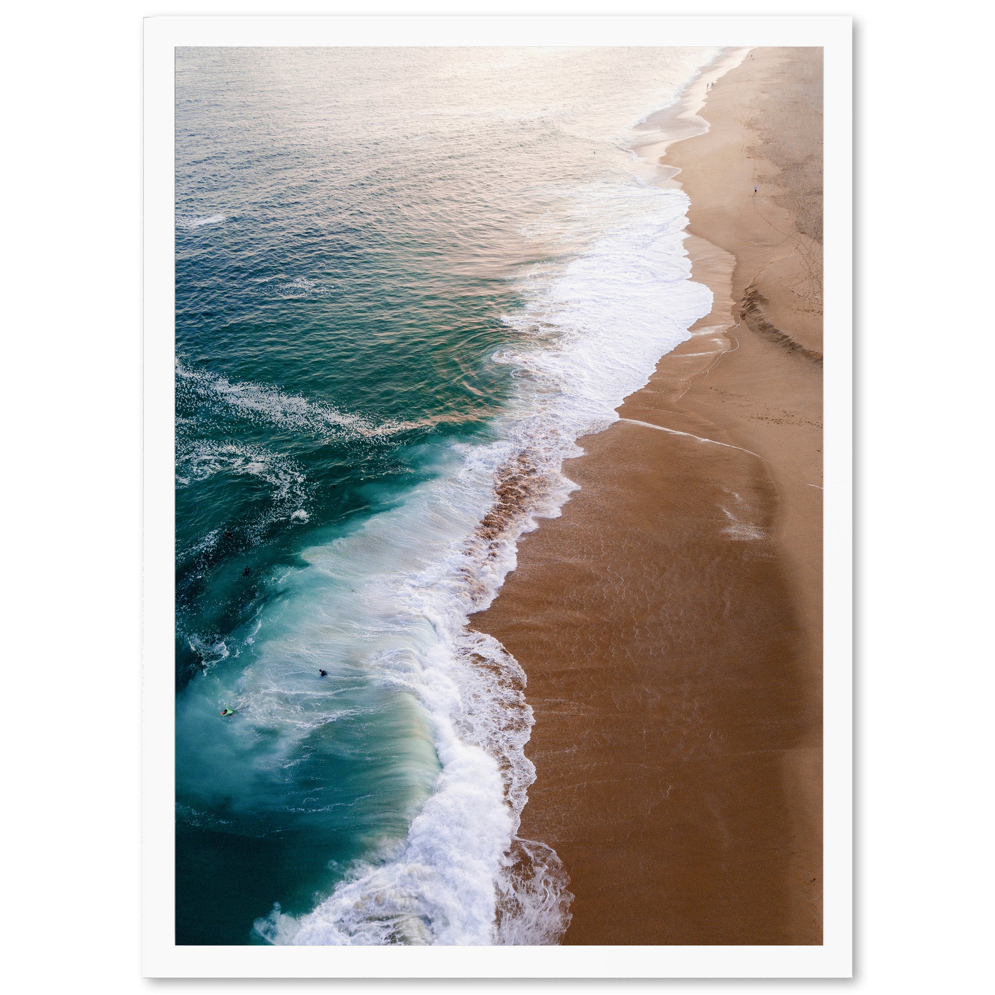 an aerial view of a beach with a wave coming in