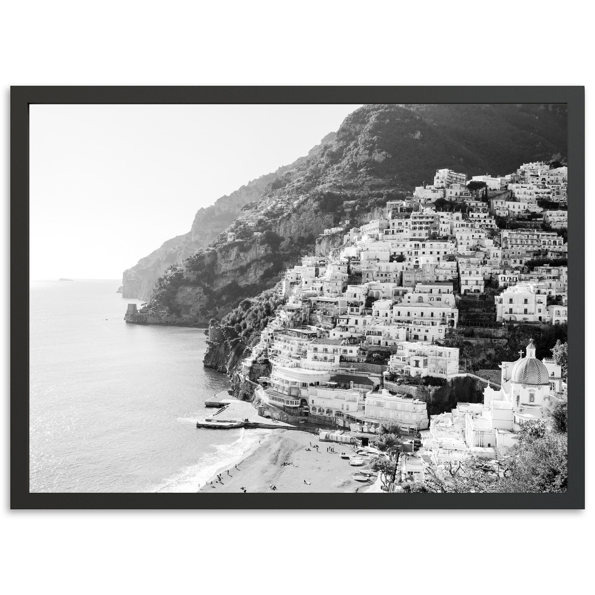 a black and white photo of a village on the beach