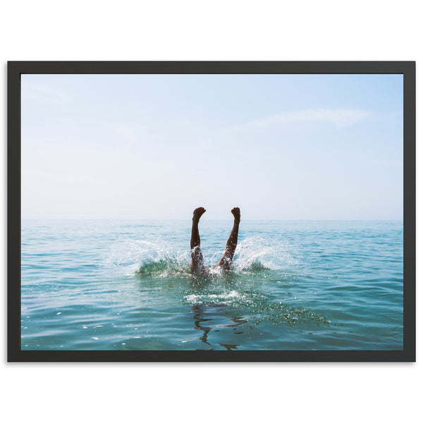 a person swimming in the ocean with their feet in the water