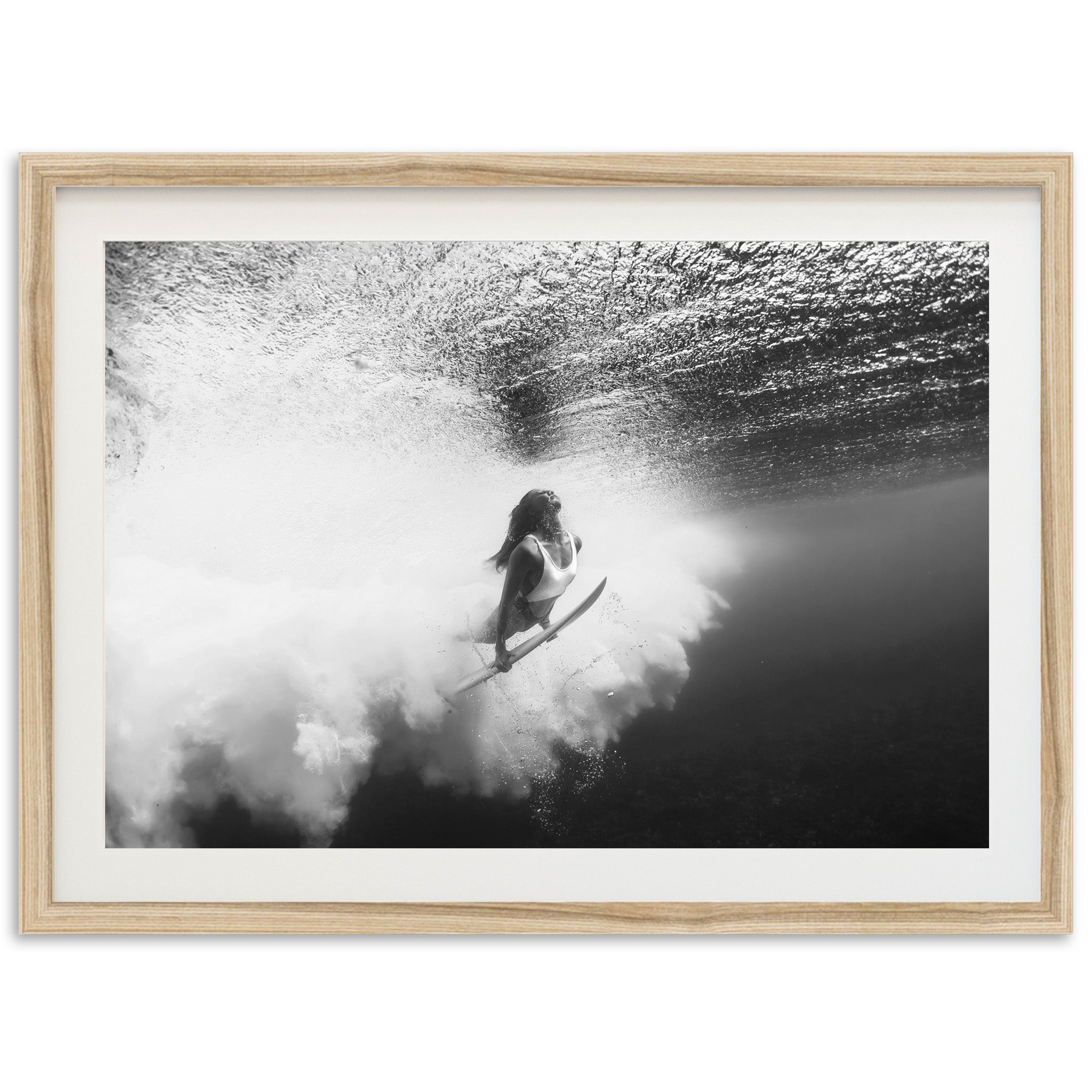 a black and white photo of a person on a surfboard