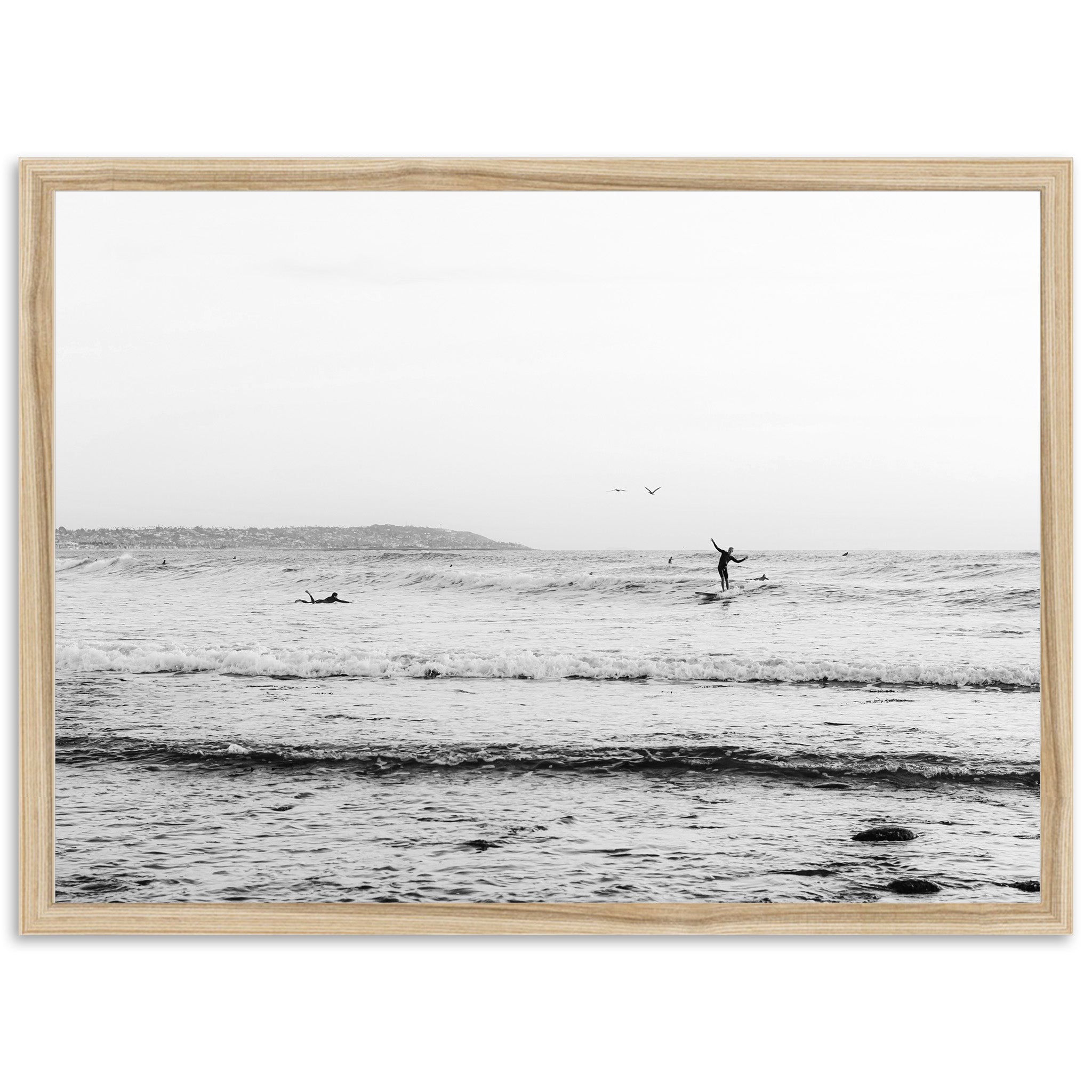 a black and white photo of a person surfing in the ocean