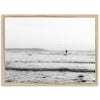 a black and white photo of a person surfing in the ocean