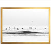 a black and white photo of surfers in the ocean