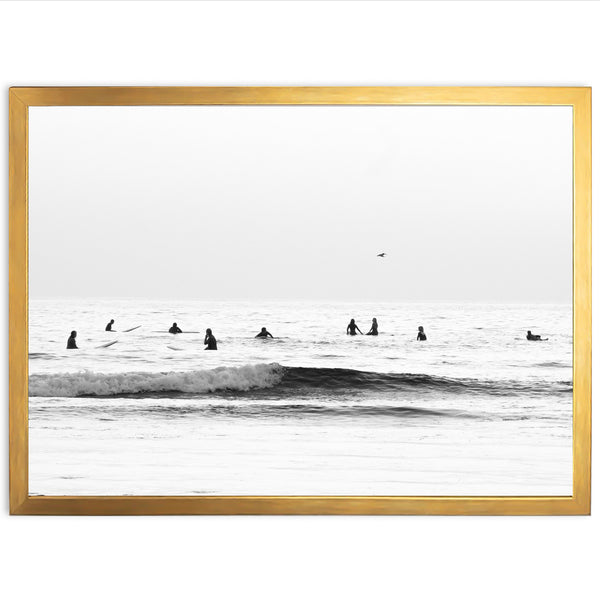 a black and white photo of surfers in the ocean