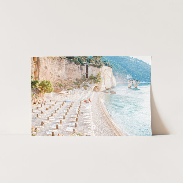 a picture of a beach with tables and chairs